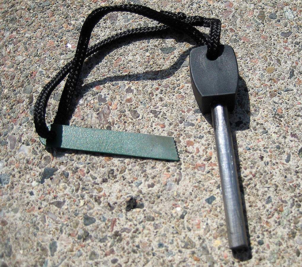A ferrocerium rod with a metal striker on a lanyard