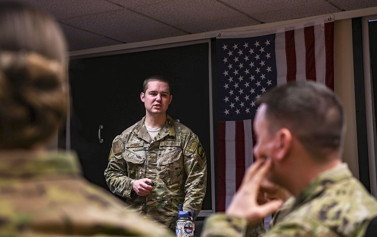 A survival instructor giving a class to seated airmen