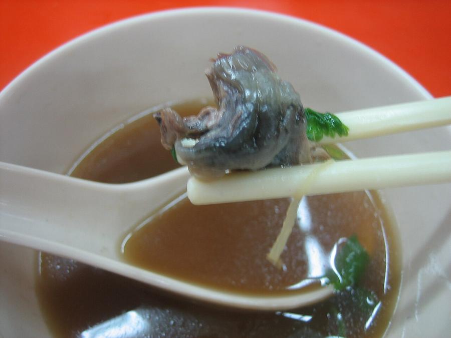Close-up of turtle soup with chunks of softshell turtle meat